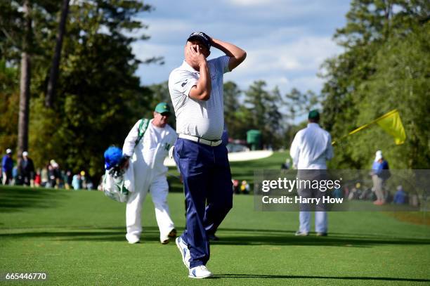 Jason Dufner of the United States adjusts his neck as he walks to the 18th tee during the first round of the 2017 Masters Tournament at Augusta...