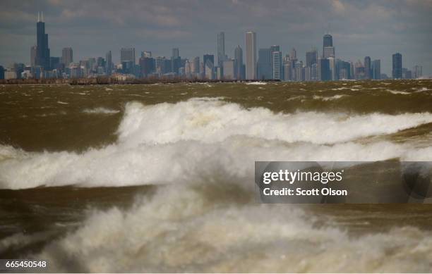 Waves from Lake Michigan crash ashore on April 6, 2017 in Whiting, Indiana. The waves were pushed ashore by sustained winds estimated to be 20-30 mph...