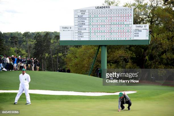 Charley Hoffman of the United States lines up his putt on the 18th green during the first round of the 2017 Masters Tournament at Augusta National...