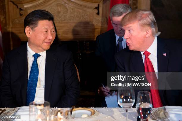 President Donald Trump and Chinese President Xi Jinping speak during dinner at the Mar-a-Lago estate in West Palm Beach, Florida, on April 6, 2017. /...