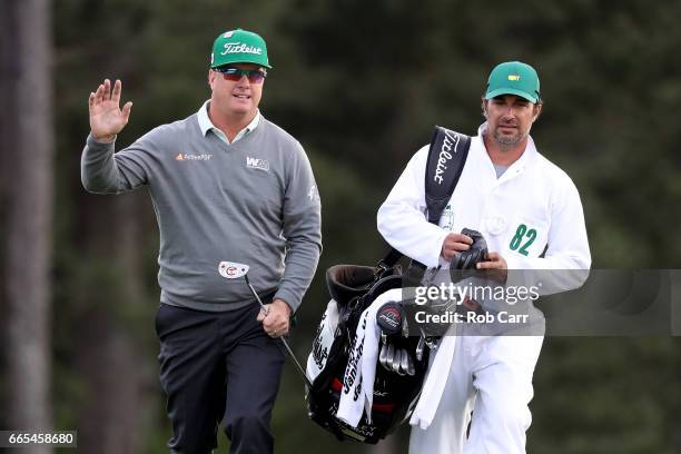 Charley Hoffman of the United States and caddie Brett Waldman react on the 18th hole during the first round of the 2017 Masters Tournament at Augusta...