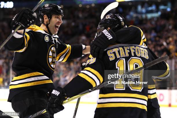Drew Stafford of the Boston Bruins celebrates with Zdeno Chara after he scored against the Ottawa Senators during the first period at TD Garden on...