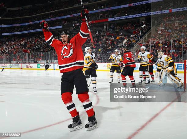 John Moore of the New Jersey Devils celebrates his goal at 10 seconds of the second period against the Pittsburgh Penguins at the Prudential Center...