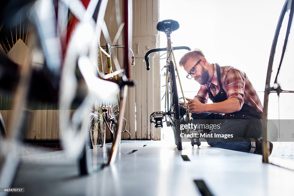 A man working in a bicycle repair shop.