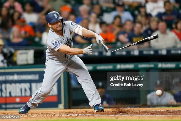 Danny Valencia of the Seattle Mariners breaks his bat as he grounds out to Yuli Gurriel of the Houston Astros in the fourth inning at Minute Maid...