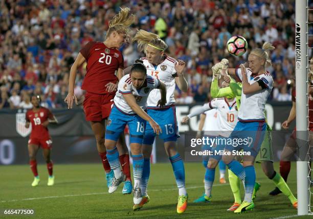 Allie Long of the USA scores on a header as she is defended by Elvira Ziiastinova of Russia during the first half of the International Friendly...