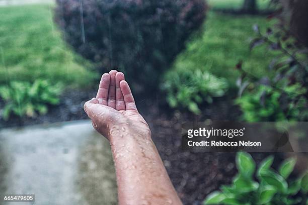 girls cupped hand catching rain - caught in rain stock pictures, royalty-free photos & images