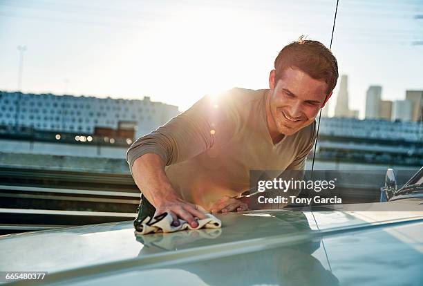 man polishing car smiling, los angeles, california, usa - polish car stock-fotos und bilder