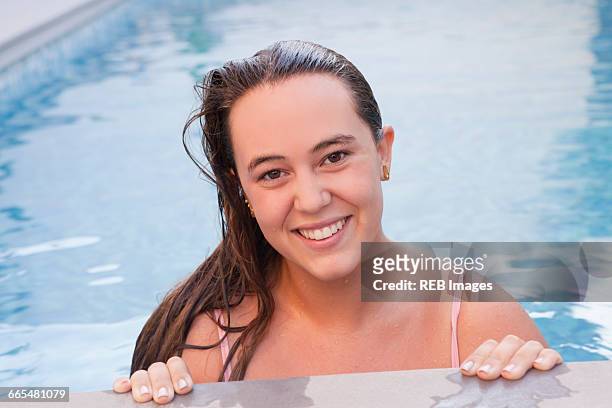 teenage girl in swimming pool looking at camera smiling - 15 years girl bare stock pictures, royalty-free photos & images