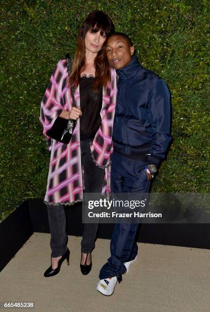 Chanel Ambassadors Caroline de Maigret and Pharrell Williams attend the celebration of Chanel's Gabrielle Bag hosted by Caroline De Maigret and...