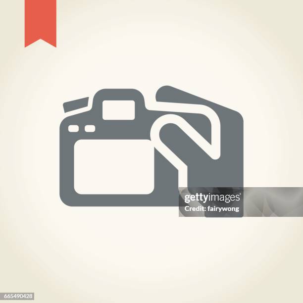 hand with photo camera icon - holding camera lens stock illustrations