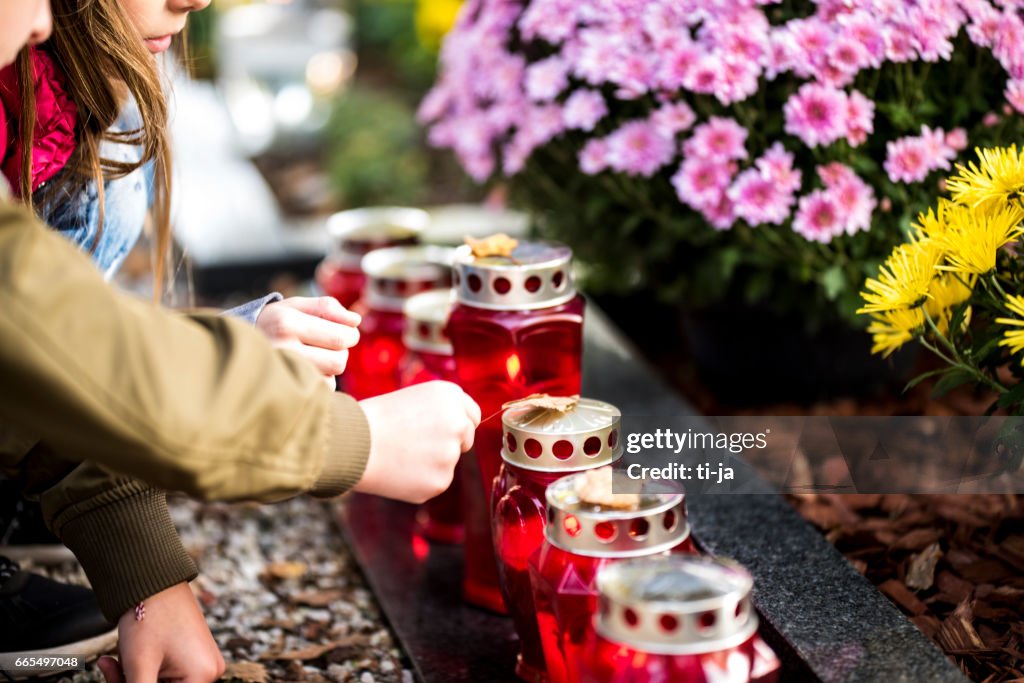 Kids and candles by the grave