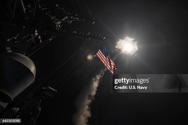 In this handout provided by the U.S. Navy,The guided-missile destroyer USS Porter fires a Tomahawk land attack missile on April 7, 2017 in the...