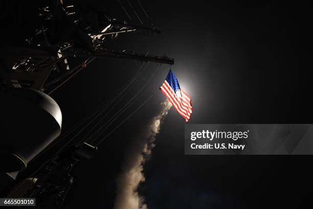 In this handout provided by the U.S. Navy,The guided-missile destroyer USS Porter fires a Tomahawk land attack missile on April 7, 2017 in the...
