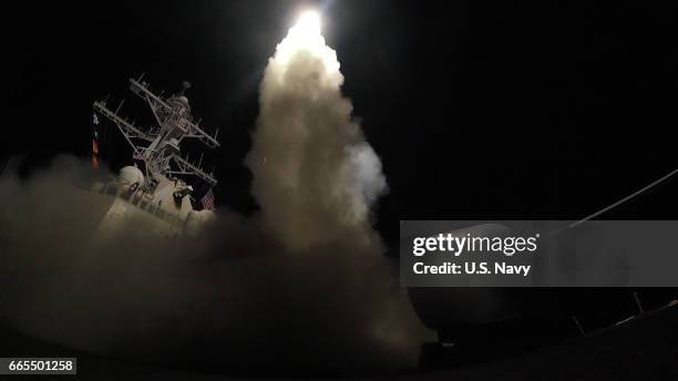 In this handout provided by the U.S. Navy,The guided-missile destroyer USS Porter fires a Tomahawk land attack missile on April 7, 2017 in the...