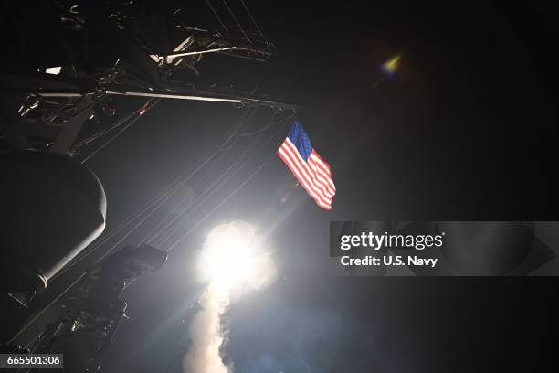 In this handout provided by the U.S. Navy,The guided-missile destroyer USS Porter fires a Tomahawk land attack missile on April 7, 2017 in the...