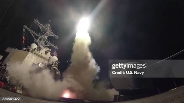 In this handout provided by the U.S. Navy,The guided-missile destroyer USS Porter fires a Tomahawk land attack missile on April 7, 2017 in the...