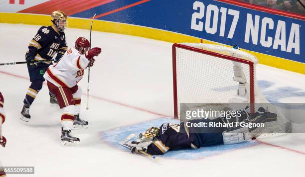 Tariq Hammond of the Denver Pioneers celebrates his goal against Cal Petersen of the Notre Dame Fighting Irish during game two of the 2017 NCAA...