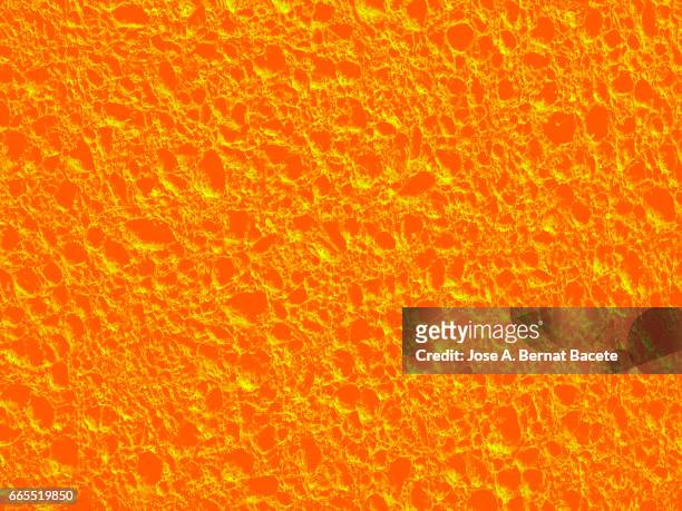 full frame of coarse and wavy textures of colored foam, orange background - rizado descripción física stock pictures, royalty-free photos & images