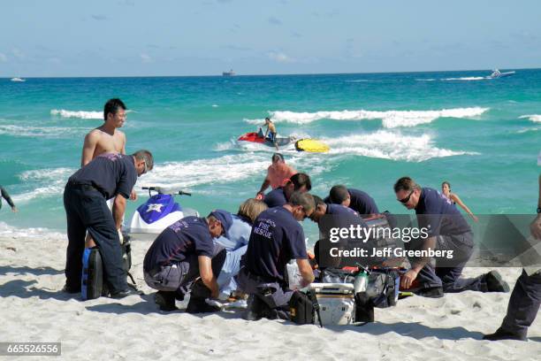 Medics helping a drowning victim on Miami Beach.