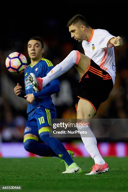 Guilherme Siqueira of Valencia CF competes for the ball with Iago Aspas of Real Club Celta de Vigo during the La Liga match between Valencia CF and...
