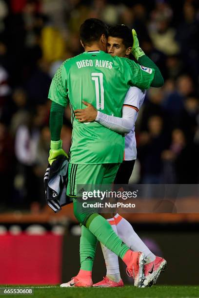 Diego Alves goalkeeper of Valencia CF embraces teammate Joao Cancelo during the La Liga match between Valencia CF and Real Club Celta de Vigo at...