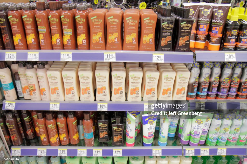 Shelves of suntan lotion for sale in Walgreens.
