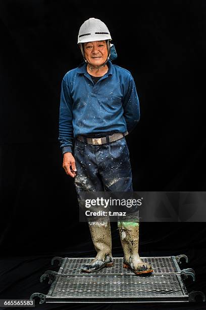 portrait of concrete craftsman 50s - construction boots stock pictures, royalty-free photos & images
