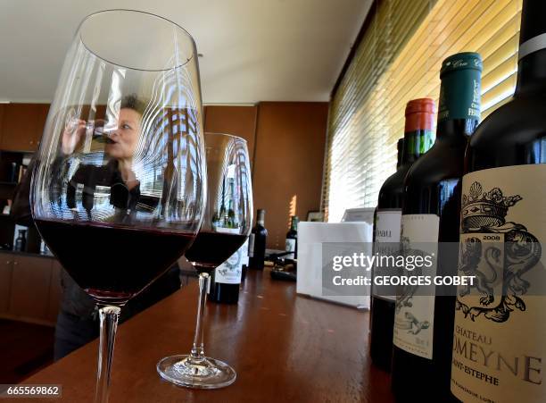 People taste wine during a tasting of the 2016 vintage Bordeaux primeurs at Chateau Ferriere in Margaux on April 4, 2017.. Professionals from all...