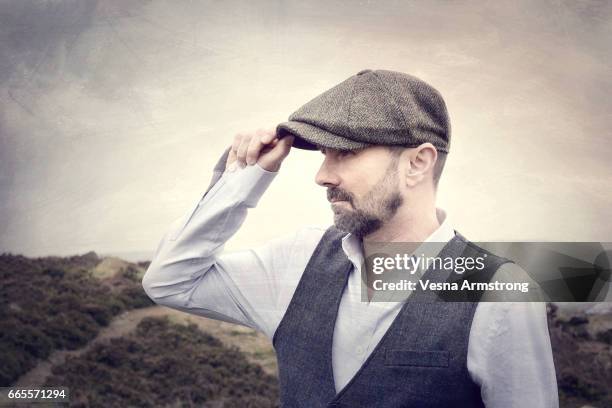 profile of man in shirt sleeves and waistcoat - baker boy cap stock-fotos und bilder