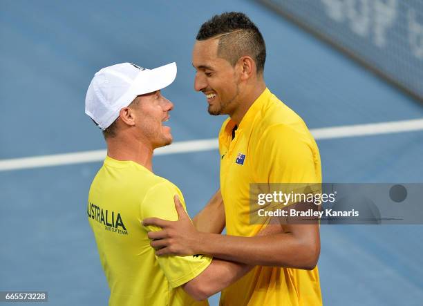 Nick Kyrgios of Australia celebrates victory with Team Captain Lleyton Hewitt after his match against John Isner of the USA during the Davis Cup...