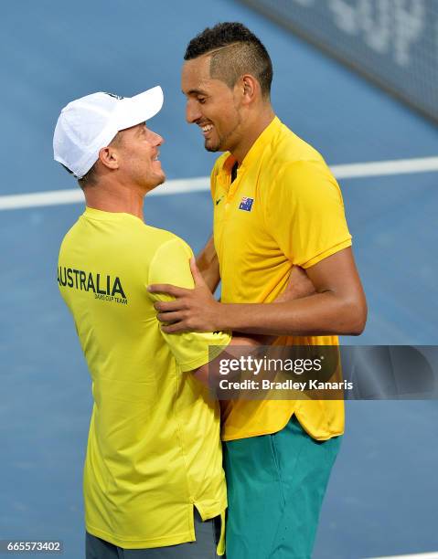 Nick Kyrgios of Australia celebrates victory with Team Captain Lleyton Hewitt after his match against John Isner of the USA during the Davis Cup...