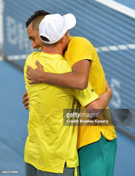 Nick Kyrgios of Australia celebrates victory with Team Captain Lleyton Hewitt after his match against John Isner of the USA during the Davis Cup...