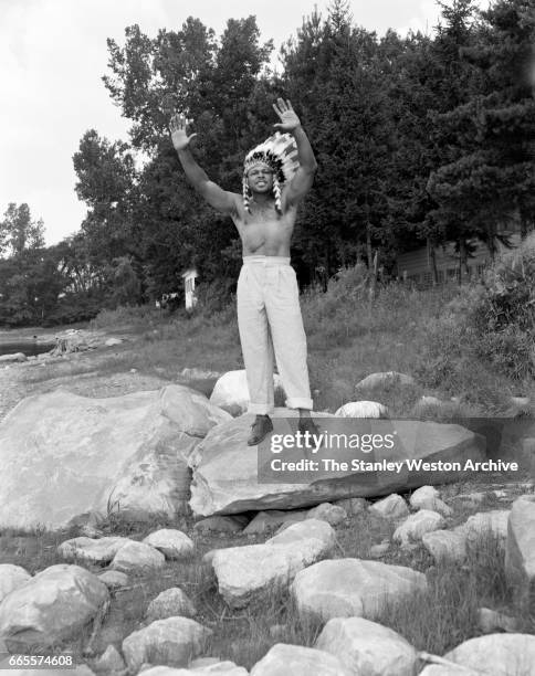 Archie Moore dressed as an Indian at this training camp in North Adams, Massachusetts, circa 1955.