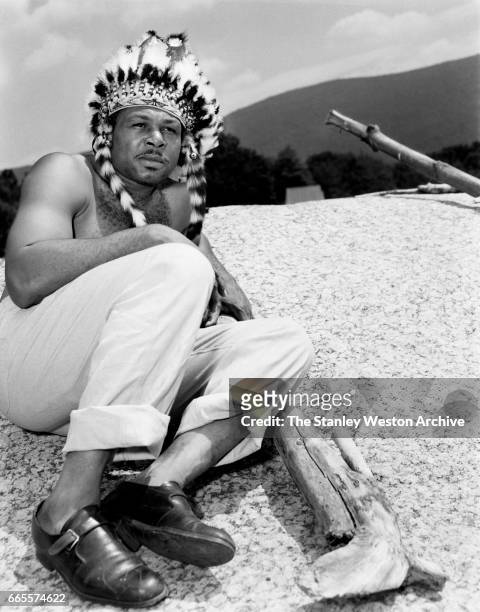 Archie Moore dressed as an Indian at this training camp in North Adams, Massachusetts, circa 1955.