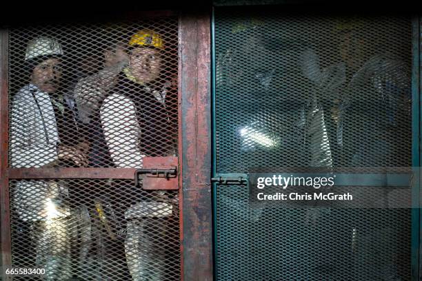 Coal miners wait in an elevator to take them back to the surface after finishing their shift at a large government run coal mine on April 4, 2017 in...