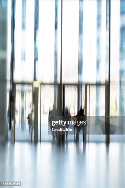 blurred people at the door - woman walking out door silhouette stock pictures, royalty-free photos & images