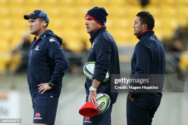 To R, Assistant coaches Chris Malone, Nathan Grey and coach Daryl Gibson of the Waratahs look on during the round seven Super Rugby match between the...