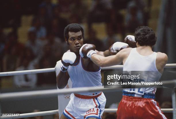 Cuban gold medal winning boxer Teofilo Stevenson pictured left in action against Grzegorz Skrzecz of Poland in the second round of the Heavyweight...