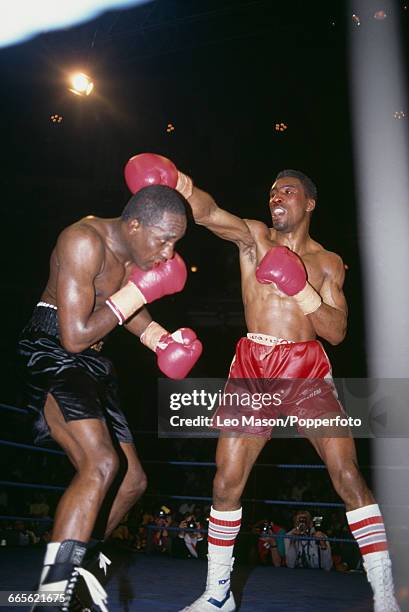 English boxer Michael Watson, pictured right in red shorts, in action during his fight against Jamaican boxer Mike McCallum, on left, at the Royal...