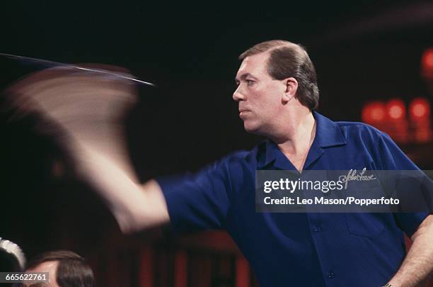 English professional darts player John Lowe pictured in action competing to progress to win the final of the 1987 BDO Embassy World Darts...