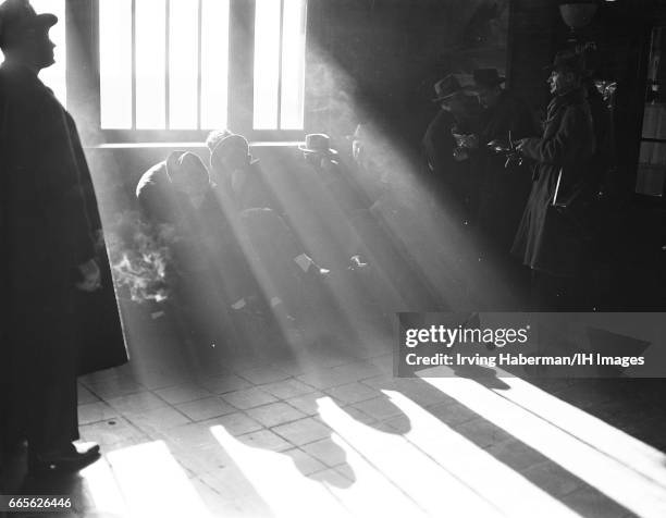 View of a group of unidentified man, allegedly gangsters associated with the so-called Murder Incorporated, as they prepare to leave Sing Sing...