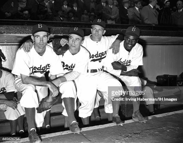 Portrait of the infield players from the Brooklyn Dodgers baseball team as they pose in the dugout during the season opener at Ebbets Field, New...