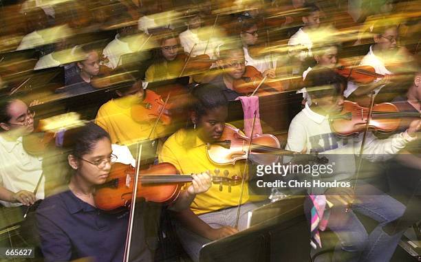 Students at "Knowledge is Power Program" Academy play string instruments during a class October 4, 2000 in The Bronx, New York. Outside of academics,...
