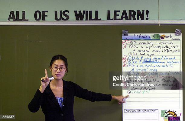 Teacher Tina Cheuk of "Knowledge is Power Program" Academy discusses how to write a persuasive essay October 4, 2000 in The Bronx, New York. The...