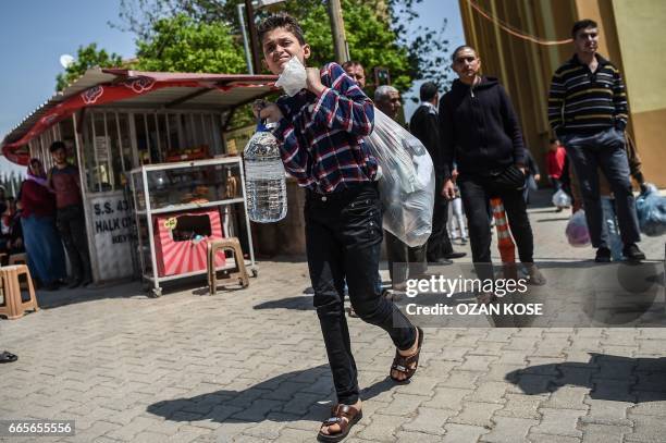 Syrian victims of an alleged chemical attack leave the Reyhanli hospital in Hatay on April 7, 2017 before being carried back to the Syrian border. On...