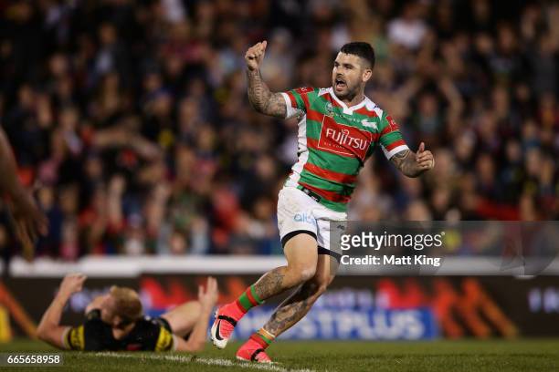Adam Reynolds of the Rabbitohs celebrates kicking the winning field goal during the round six NRL match between the Penrith Panthers and the South...