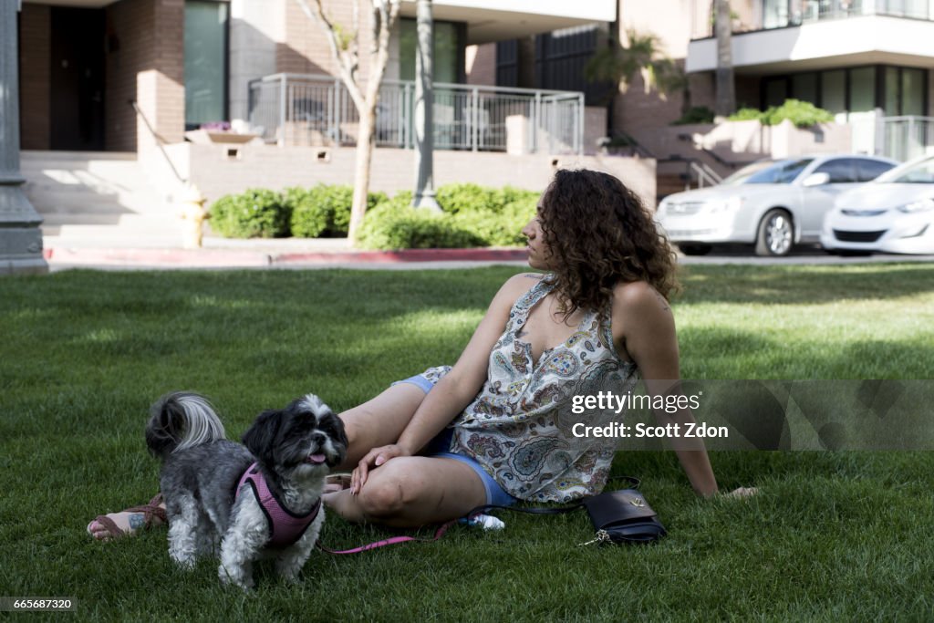 Woman sitting in park with dog