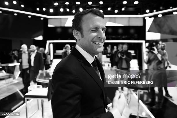 French presidential election candidate for the En Marche ! movement Emmanuel Macron winks as he arrives to take part in the political TV show...