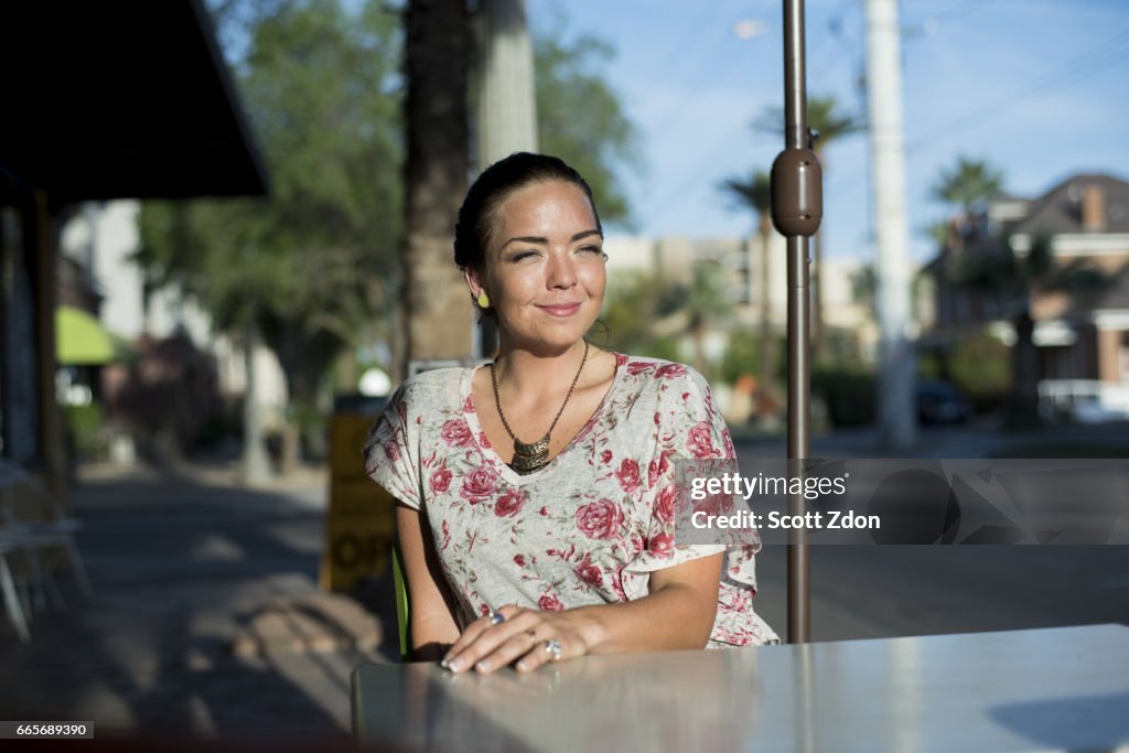 Woman sitting outside at neighborhood cafe